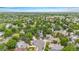 Expansive aerial view of a lush neighborhood with mature trees and well-maintained homes beneath a blue sky at 1181 E 130Th Pl, Thornton, CO 80241