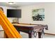 Basement game room with a billiards table, television, and unique wall decor at 1181 E 130Th Pl, Thornton, CO 80241