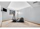 Basement workout area with modern fitness equipment, including an elliptical machine and a TV at 1181 E 130Th Pl, Thornton, CO 80241