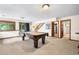 Basement recreational area featuring a pool table, natural light, and multiple entryways at 1181 E 130Th Pl, Thornton, CO 80241