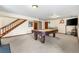 Spacious basement featuring a pool table, with a nearby staircase and access to other rooms at 1181 E 130Th Pl, Thornton, CO 80241