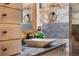 Close up view of bathroom sink and decorative tile, featuring an elegant stone basin and black faucet at 1181 E 130Th Pl, Thornton, CO 80241