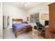 Bedroom with a queen size bed, wood headboard, a window and a work area at 1181 E 130Th Pl, Thornton, CO 80241