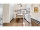 A corner breakfast nook with storage cabinets, wood floors and view from a bright window at 1181 E 130Th Pl, Thornton, CO 80241