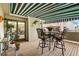 Outdoor deck with seating, awning, and access to the home interior at 1181 E 130Th Pl, Thornton, CO 80241