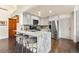 Kitchen featuring bar seating, marble countertop, stainless steel appliances and white cabinets at 1181 E 130Th Pl, Thornton, CO 80241