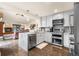 Modern kitchen featuring white cabinets, stainless steel appliances, and marble countertops at 1181 E 130Th Pl, Thornton, CO 80241