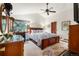 Spacious bedroom with large windows, vaulted ceiling, wooden furniture and a ceiling fan at 1181 E 130Th Pl, Thornton, CO 80241