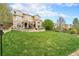 Sprawling backyard with lush green lawn, stone retaining wall and multi-level patio at 2349 Hickory Pl, Erie, CO 80516