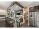 Stylish bar area with counter seating, perfect for entertaining guests and pouring drinks at 2349 Hickory Pl, Erie, CO 80516