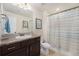 Well-lit bathroom with a vanity, mosaic tile details, and a shower with a striped curtain at 2349 Hickory Pl, Erie, CO 80516