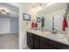 Well-lit bathroom with double vanity, large mirror, and mosaic tile backsplash at 2349 Hickory Pl, Erie, CO 80516