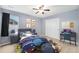 Stylish bedroom with playful planetary theme, a workspace desk, and natural lighting at 2349 Hickory Pl, Erie, CO 80516