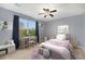 Cheerful bedroom with blue walls, large window, and whimsical decor at 2349 Hickory Pl, Erie, CO 80516