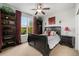 Inviting bedroom offering views of the golf course with stylish decor, including dark wood bookcases at 2349 Hickory Pl, Erie, CO 80516