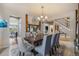 Elegant dining room featuring a stylish chandelier, seating for eight, and easy access to the staircase at 2349 Hickory Pl, Erie, CO 80516
