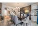 Chic dining room featuring a decorative tiled accent wall, chandelier, and seating for six to eight people at 2349 Hickory Pl, Erie, CO 80516