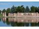 Community entrance to Vista Ridge with a pond in front and stone pillars, creating a welcoming atmosphere at 2349 Hickory Pl, Erie, CO 80516