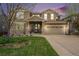 Beautiful two-story home with stone accents, a landscaped yard, and a charming front porch at 2349 Hickory Pl, Erie, CO 80516