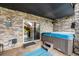 Secluded hot tub area with stone walls and accents, providing a private and luxurious relaxation experience at 2349 Hickory Pl, Erie, CO 80516