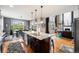 Open kitchen with large island, stainless steel appliances, and dining area at 2349 Hickory Pl, Erie, CO 80516