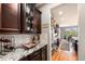 Gourmet kitchen area showcasing granite countertops and modern appliances next to a dining space with golf course views at 2349 Hickory Pl, Erie, CO 80516