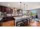 Well-appointed kitchen with a central island and adjoining dining area, ideal for Gathering meals at 2349 Hickory Pl, Erie, CO 80516