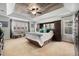 Spacious main bedroom featuring a unique wood plank ceiling, plush carpeting, and light teal colored walls at 2349 Hickory Pl, Erie, CO 80516
