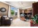 Bright home office with a large window, custom built-ins, and a comfortable seating area for work at 2349 Hickory Pl, Erie, CO 80516