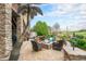 Outdoor patio with a fire pit, a palm tree, and comfortable seating, perfect for entertaining with golf course views at 2349 Hickory Pl, Erie, CO 80516