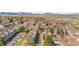 Aerial view of residential neighborhood with attached homes, mature trees, and mountain views at 8773 W Cornell Ave # 10, Lakewood, CO 80227