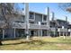 Exterior view of multi-story condos with gray exterior, multiple decks, large sliding glass doors and grass lawn at 8773 W Cornell Ave # 10, Lakewood, CO 80227