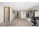 Basement with neutral carpet, adjacent to laundry closet and under stair storage, great flexible space at 8773 W Cornell Ave # 10, Lakewood, CO 80227