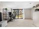 Basement features sliding glass door to exterior green space with a flexible work space with custom shelving at 8773 W Cornell Ave # 10, Lakewood, CO 80227