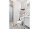 Bathroom with tile floor and walk-in shower, white vanity, and modern fixtures plus floating shelves at 8773 W Cornell Ave # 10, Lakewood, CO 80227