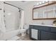 Modern bathroom with a tub, shower, and vanity with sleek hardware, offering convenience and style at 8773 W Cornell Ave # 10, Lakewood, CO 80227