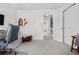 Bedroom with closet and open entry to hallway, neutral carpet and white walls offering a light and airy feel at 8773 W Cornell Ave # 10, Lakewood, CO 80227