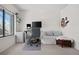 Bedroom with desk and sleeper, offering cozy space with a large window for ample natural light at 8773 W Cornell Ave # 10, Lakewood, CO 80227
