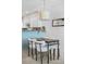 Dining area with modern lighting and an open view of the kitchen and living room at 8773 W Cornell Ave # 10, Lakewood, CO 80227