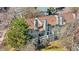 Aerial view of multi-story condo building with brown roof, gray exterior, chimneys, and multiple decks and balconies at 8773 W Cornell Ave # 10, Lakewood, CO 80227