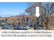 Exterior view of the home showcasing the well-kept property with a parking area and blue skies at 8773 W Cornell Ave # 10, Lakewood, CO 80227