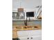 Kitchen with stainless sink, white cabinets, granite countertop, and view of the living area at 8773 W Cornell Ave # 10, Lakewood, CO 80227