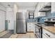 Contemporary kitchen with stainless steel appliances, white cabinets, and tiled floor at 8773 W Cornell Ave # 10, Lakewood, CO 80227