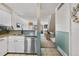 Beautiful kitchen featuring white cabinets, stainless steel appliances, and access to the living room at 8773 W Cornell Ave # 10, Lakewood, CO 80227