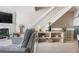 Cozy living room featuring a fireplace, staircase, and neutral decor, creating a warm and inviting atmosphere at 8773 W Cornell Ave # 10, Lakewood, CO 80227