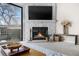 Inviting living room with a stone fireplace, TV, and access to an outdoor patio at 8773 W Cornell Ave # 10, Lakewood, CO 80227