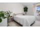 Spacious bedroom with stylish plants, and a window, offering a tranquil retreat at 8773 W Cornell Ave # 10, Lakewood, CO 80227