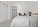 Bright bedroom featuring neutral tones, closet, and access to the hallway at 8773 W Cornell Ave # 10, Lakewood, CO 80227