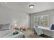 Bedroom showcasing two beds, large windows with plantation shutters, and neutral decor at 334 Green Rock Pl, Monument, CO 80132