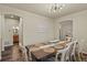 Charming dining room with a wooden table, elegant chandelier, and adjacent bathroom, ideal for gatherings at 334 Green Rock Pl, Monument, CO 80132